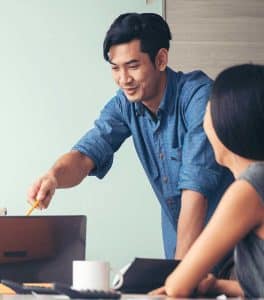 Man assisting colleague at work