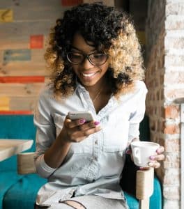 Woman on phone with coffee in hand