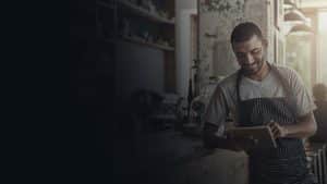 Barista using tablet in coffee shop