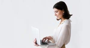 Woman looking at Affinity Payroll's resources on laptop