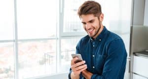 Young man accessing Affinity Self Service on his mobile phone
