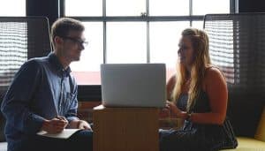 Colleagues discussing leave in an office booth