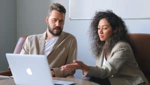 Colleagues discussing payroll non-compliance issues
