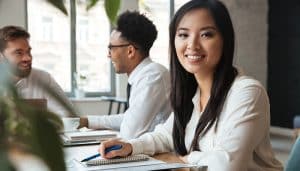 Woman working alongside colleagues in an office